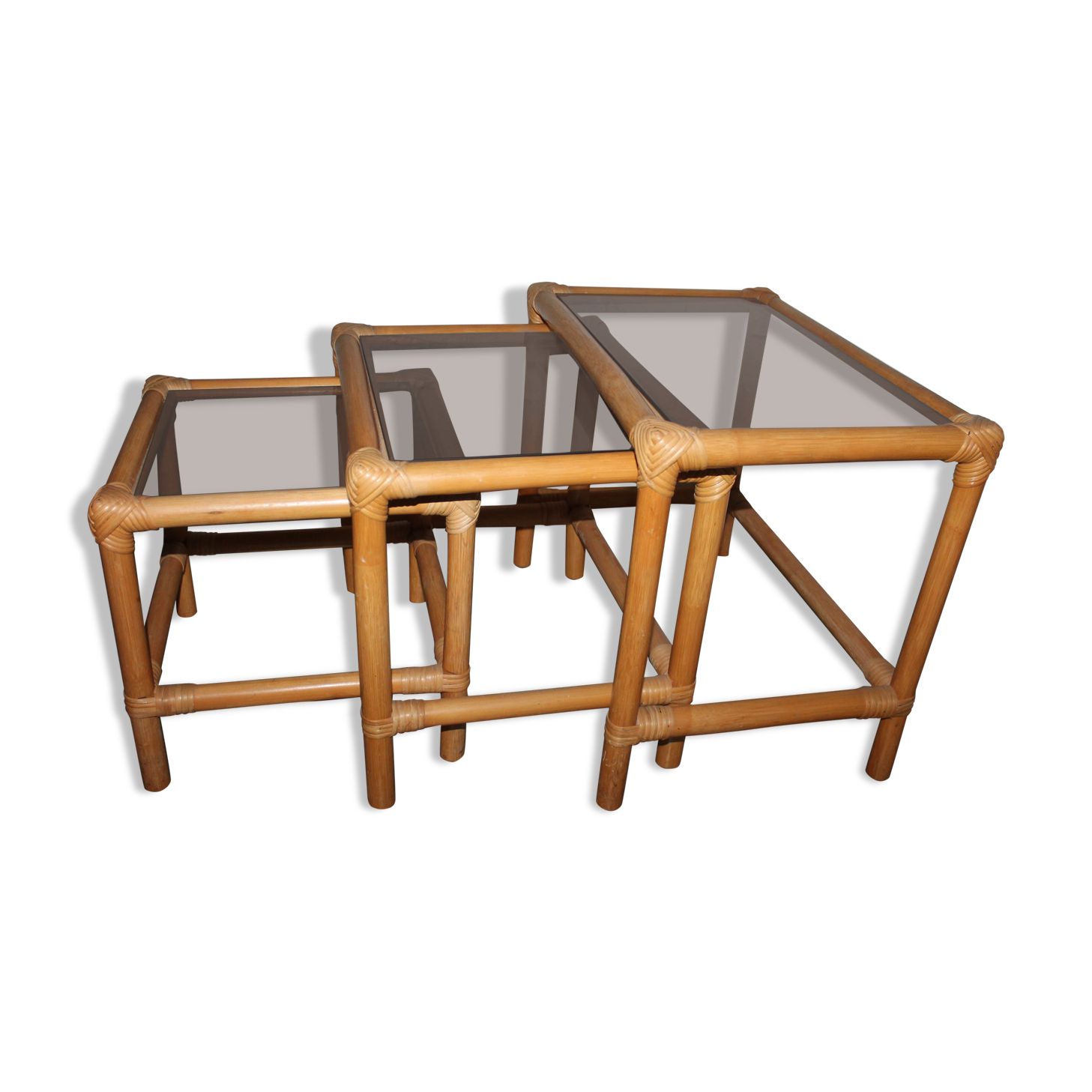 Rattan nesting tables in rattan and smoked glass from the 70s