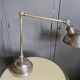 Old adjustable industrial lamp in bronze with 2 arms.