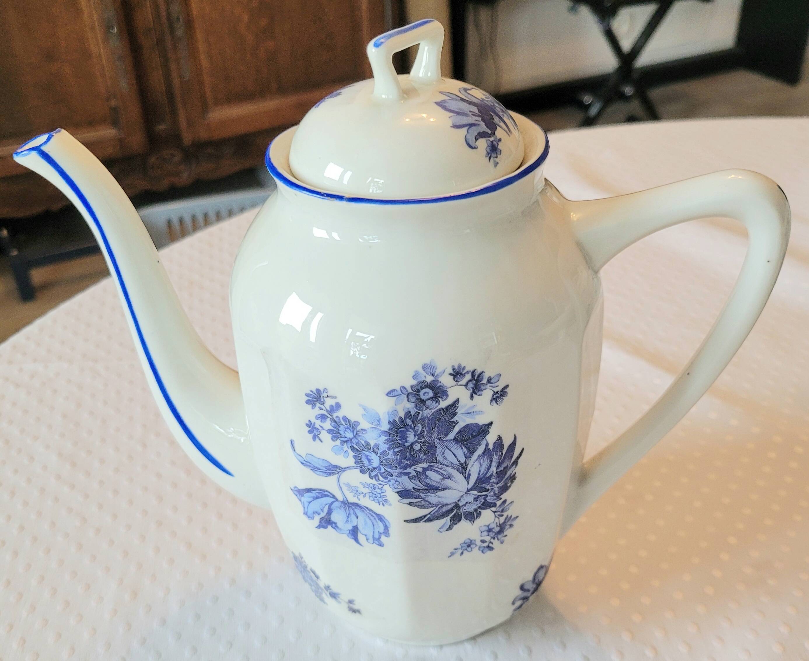 Blue and white ceramic coffee service with flowers.