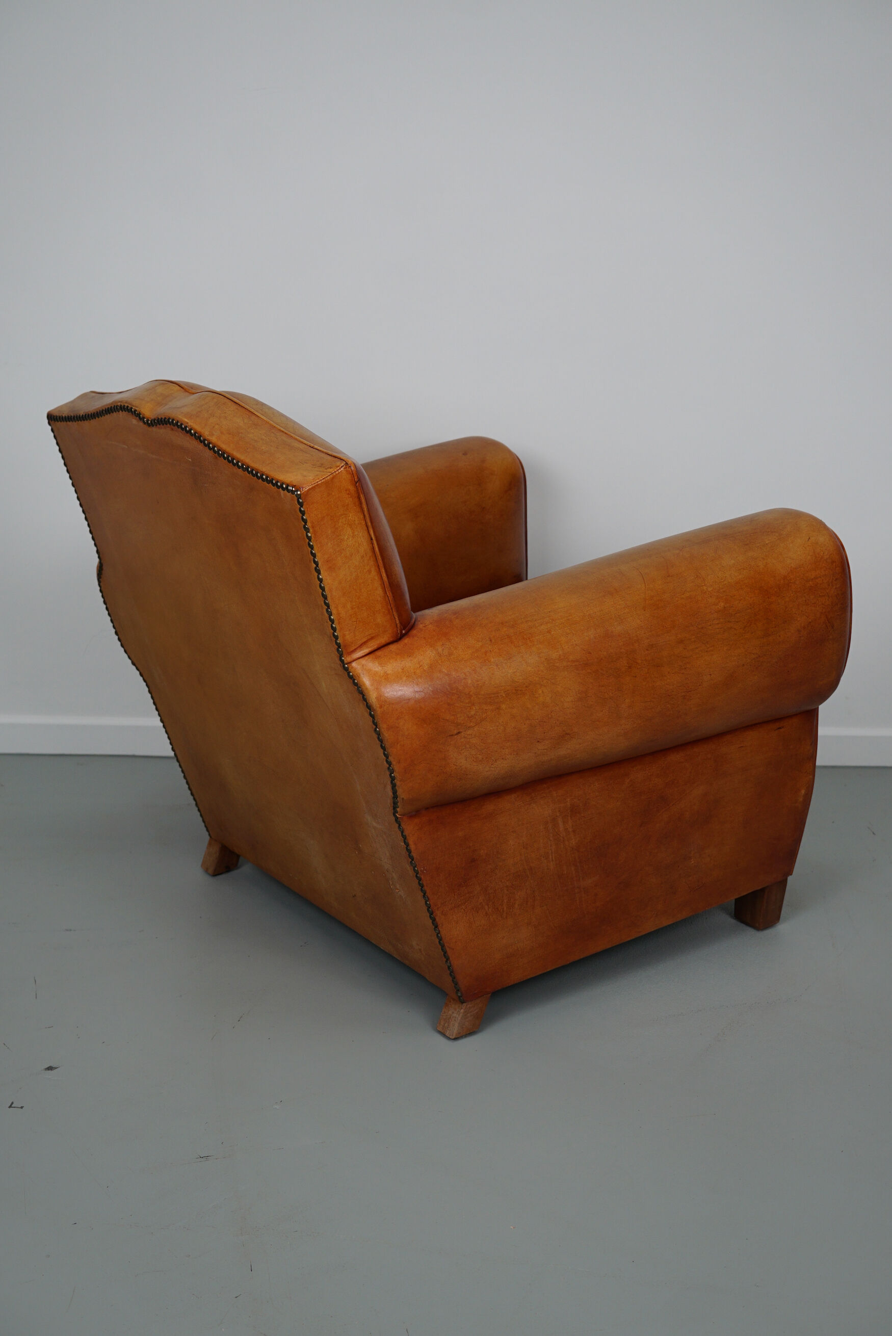 Vintage french moustache back cognac-colored leather club chair