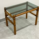 Blonde wood coffee table with smoked glass and leather bindings.