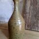 Bottled sandstone vase with a narrow neck