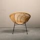 Round rattan lounge chair with black metal frame