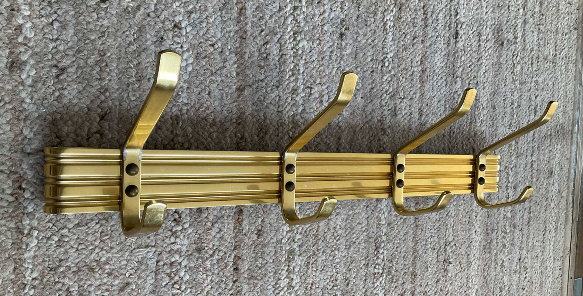 Golden wall-mounted coat rack from the 70s.