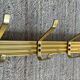 Golden wall-mounted coat rack from the 70s.