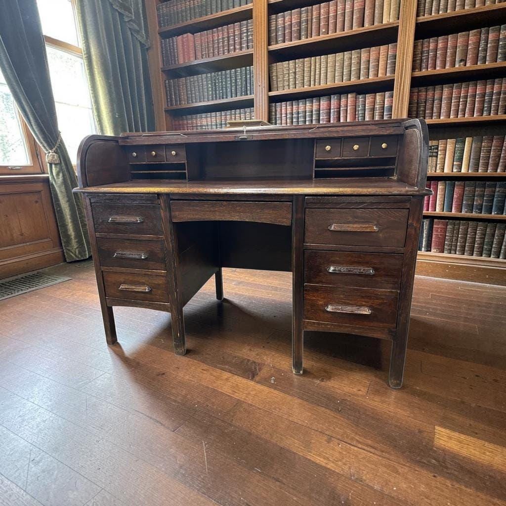 Vintage American wooden desk with a roll-top.