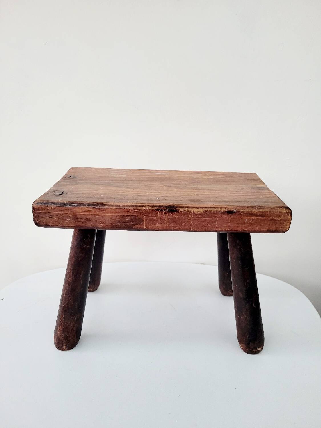 Old small solid wood milking stool