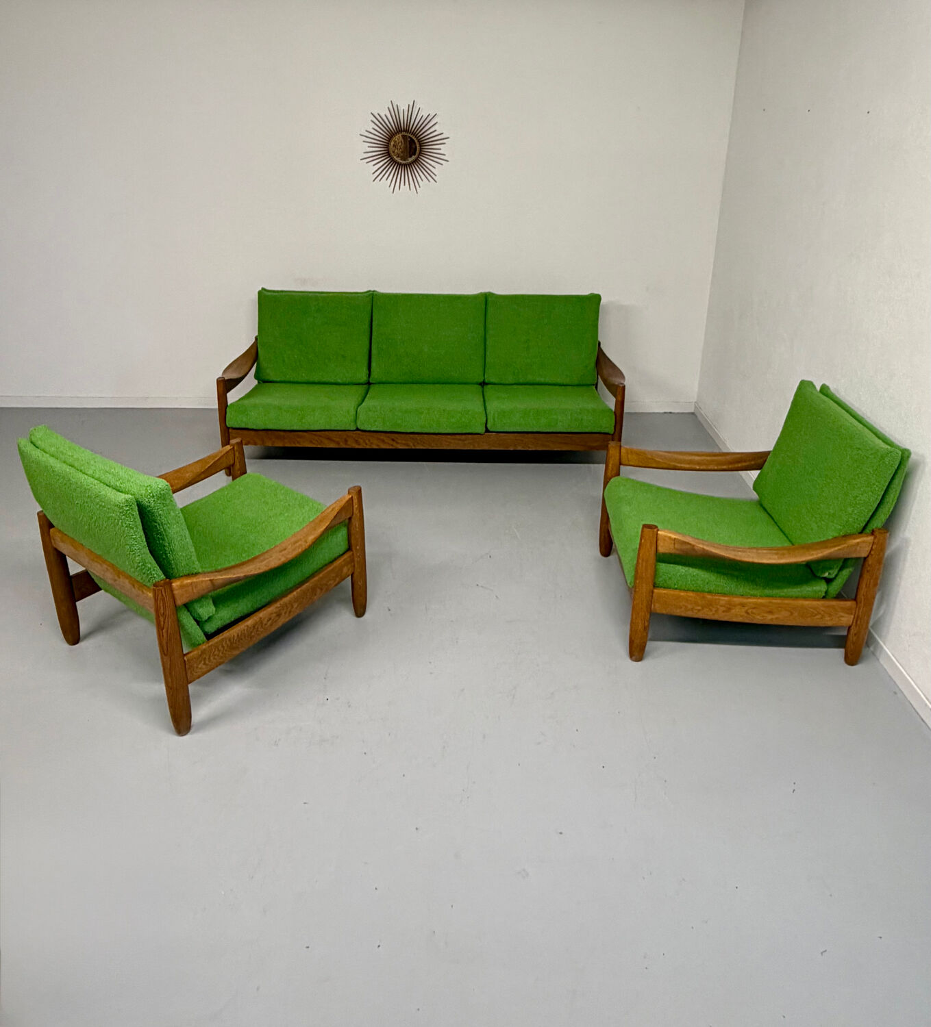 Living room sofa and Scandinavian design armchairs from the 1960s in green boucle.