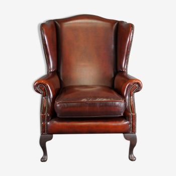 Leather armchair with decorative nails