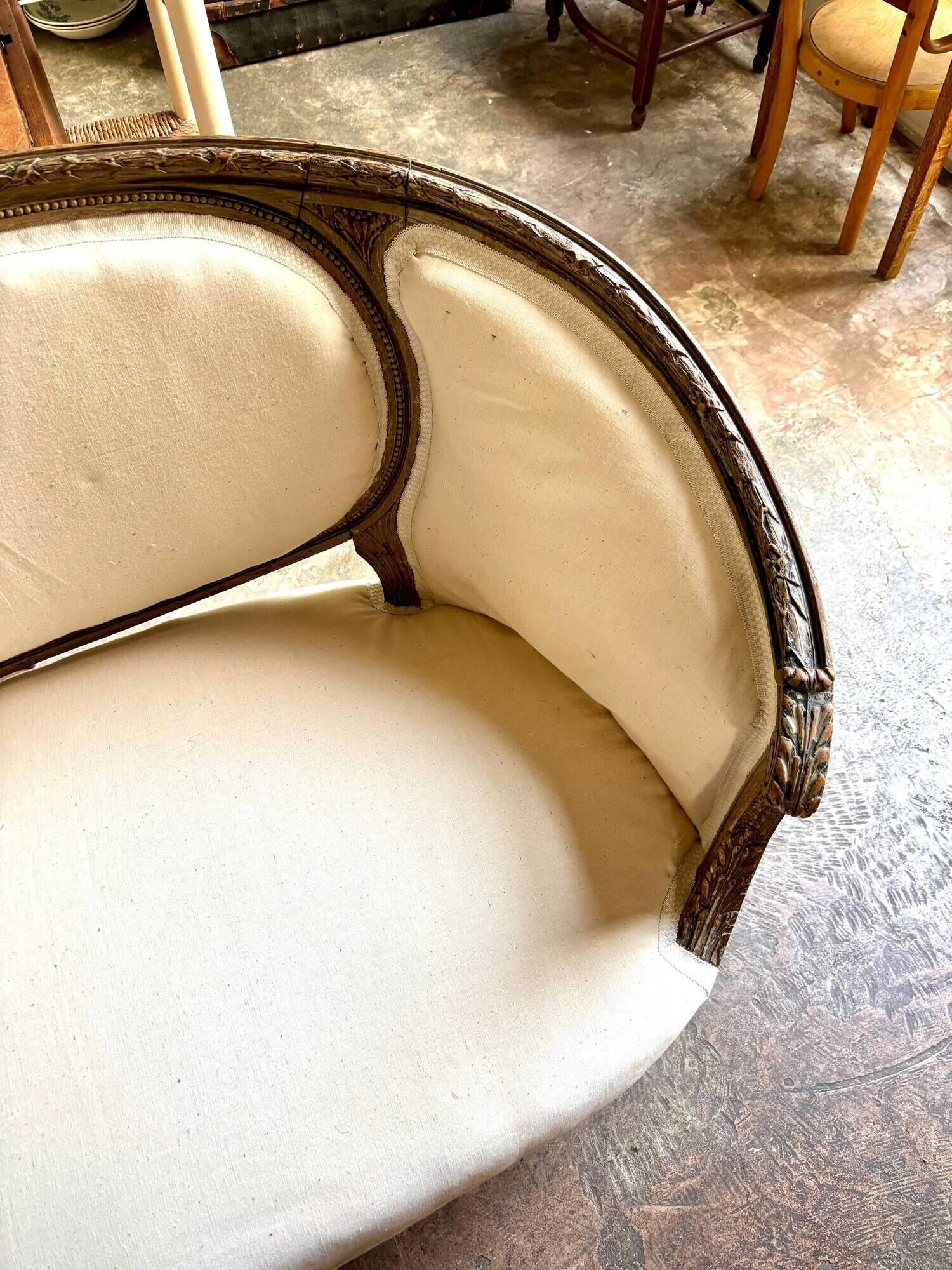 Two-seater basket bench in carved wood and beige mixed fabric, 18th century.