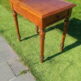 Antique solid wood table with a through drawer.