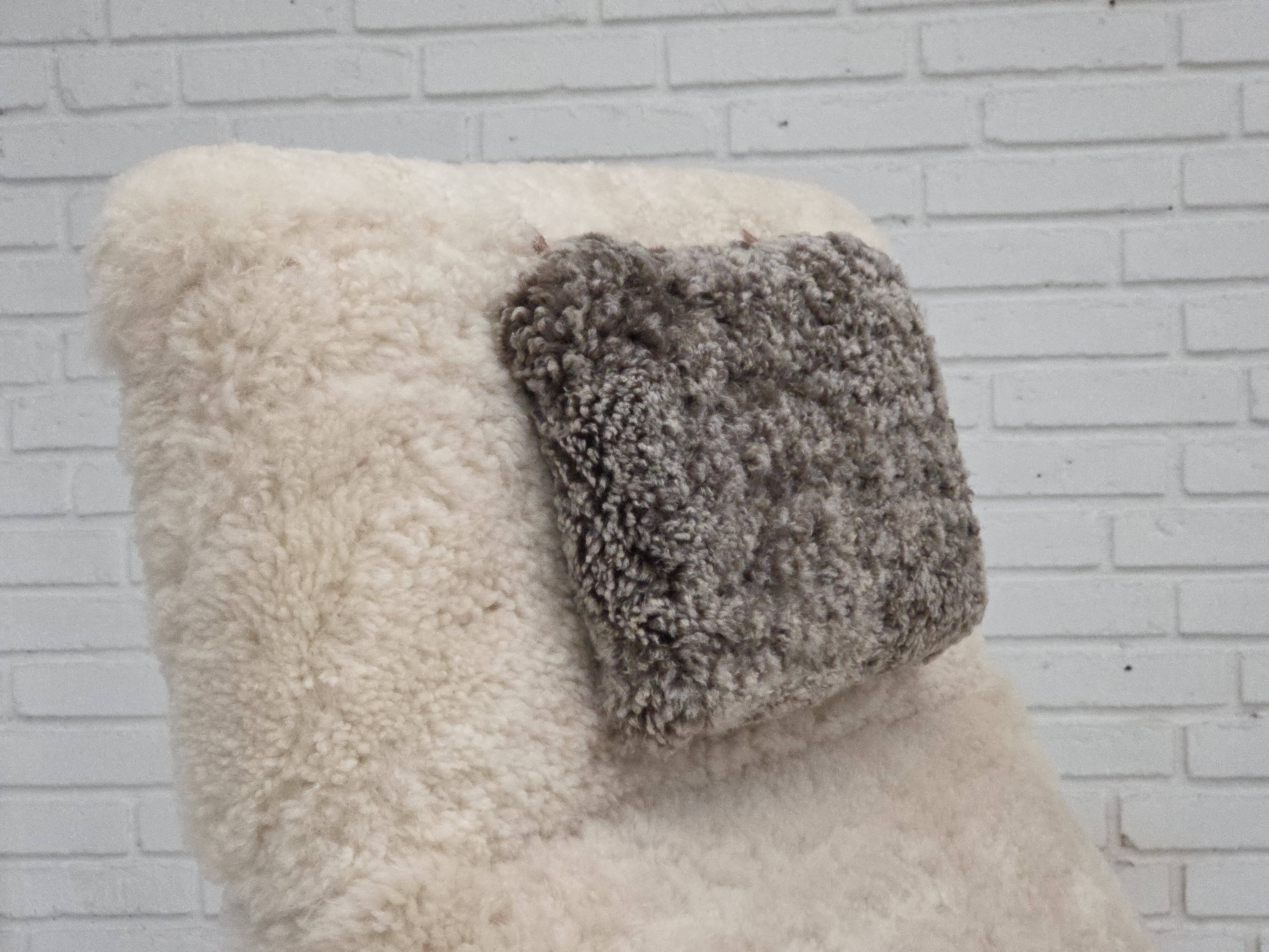 1970s, Danish rocking chair, reupholstered in quality genuine sheepskin.