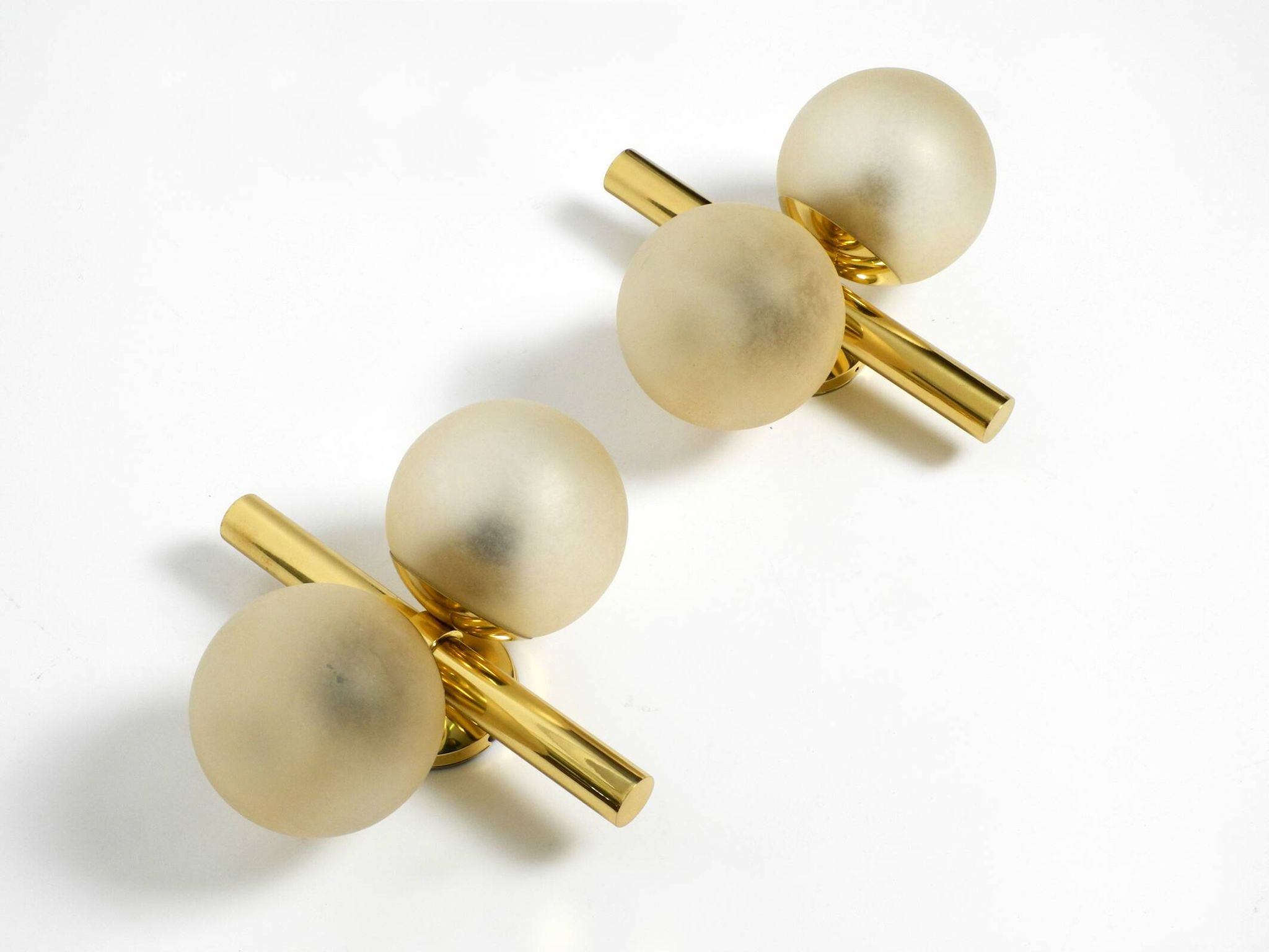 Pair of beautiful 60s Kaiser brass wall lamps with two golden glass spheres