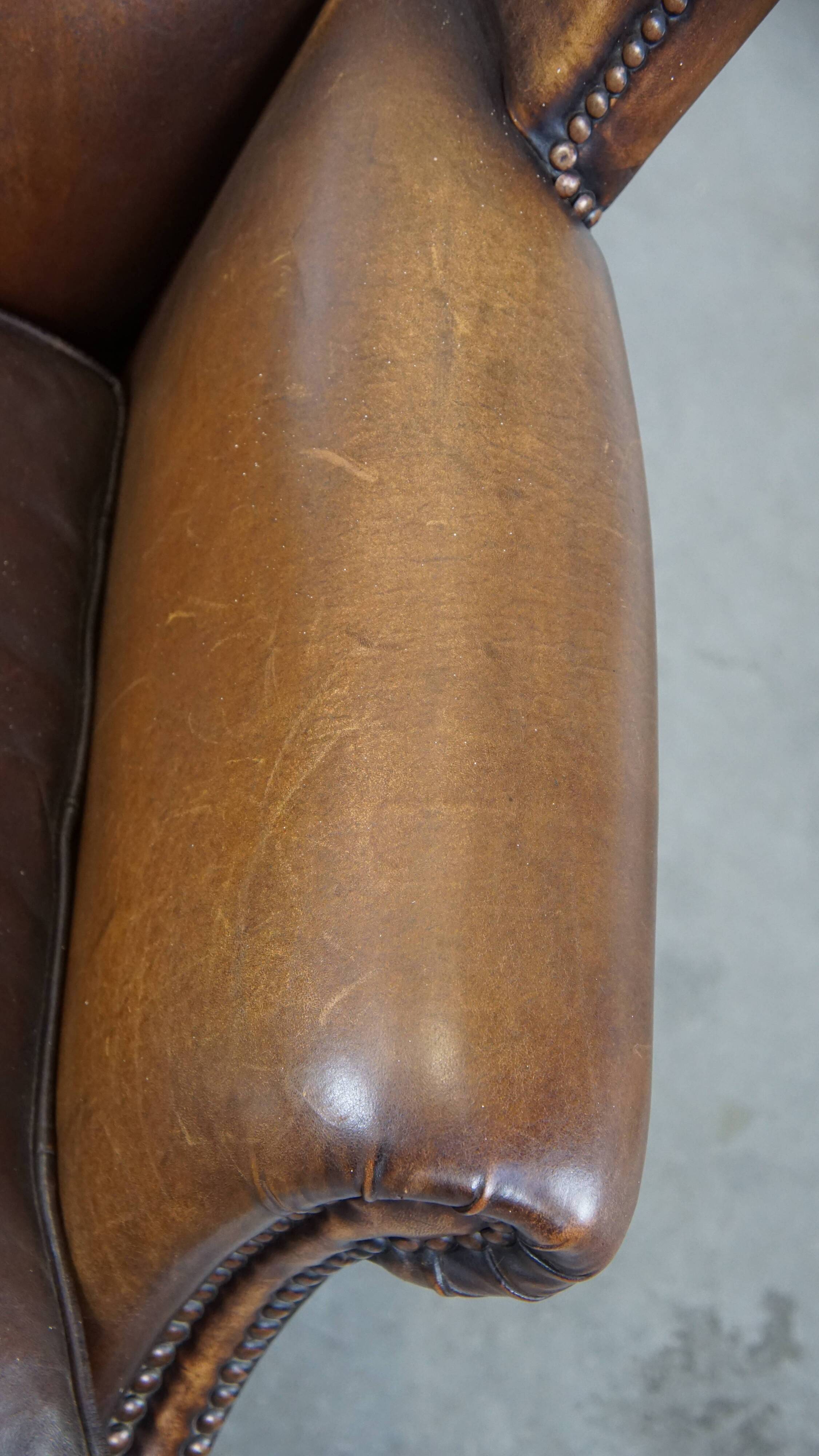 Fauteuil en cuir de mouton avec finition clous décoratifs