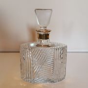 Cut glass carafe with a gold band on the neck.