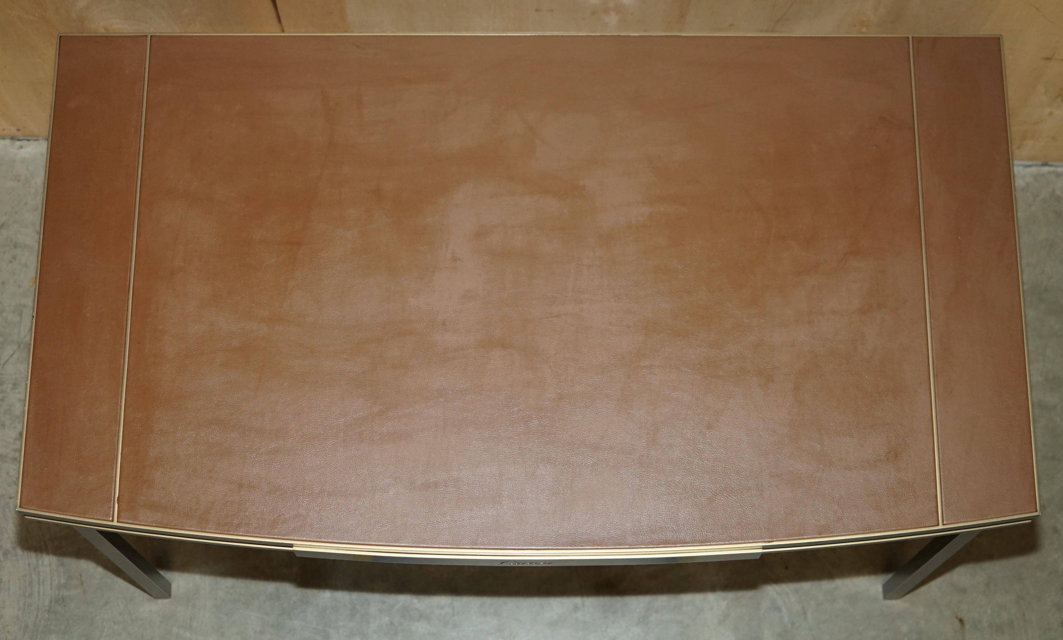 Modern mid-century writing desk signed Cartier in bronze and leather.