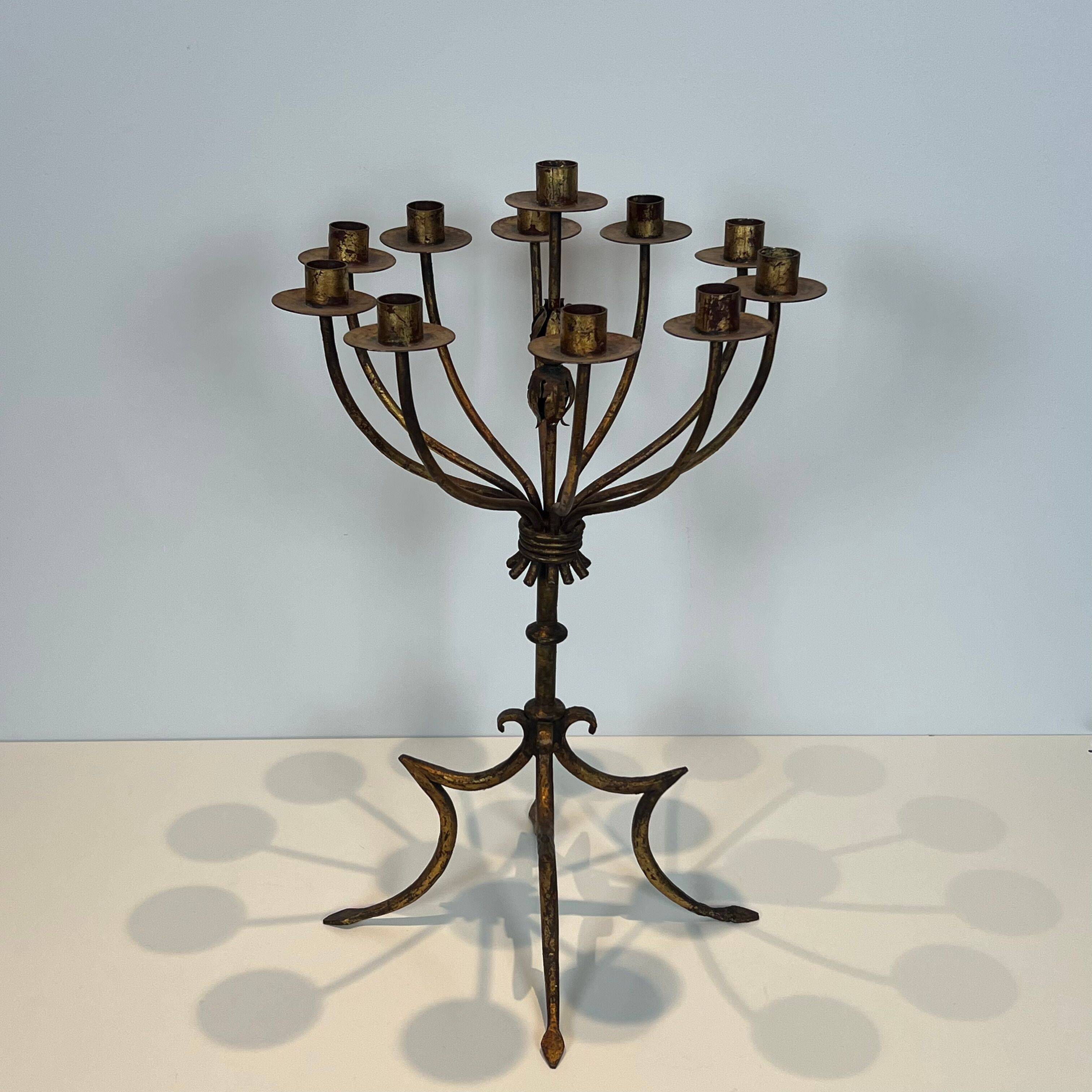 Important gilded wrought iron candelabrum with 11 arms.