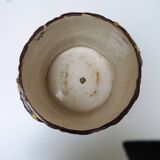 Old earthenware pot with ivy decoration.