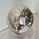 Nutcracker in the shape of a nut in silver-plated metal.