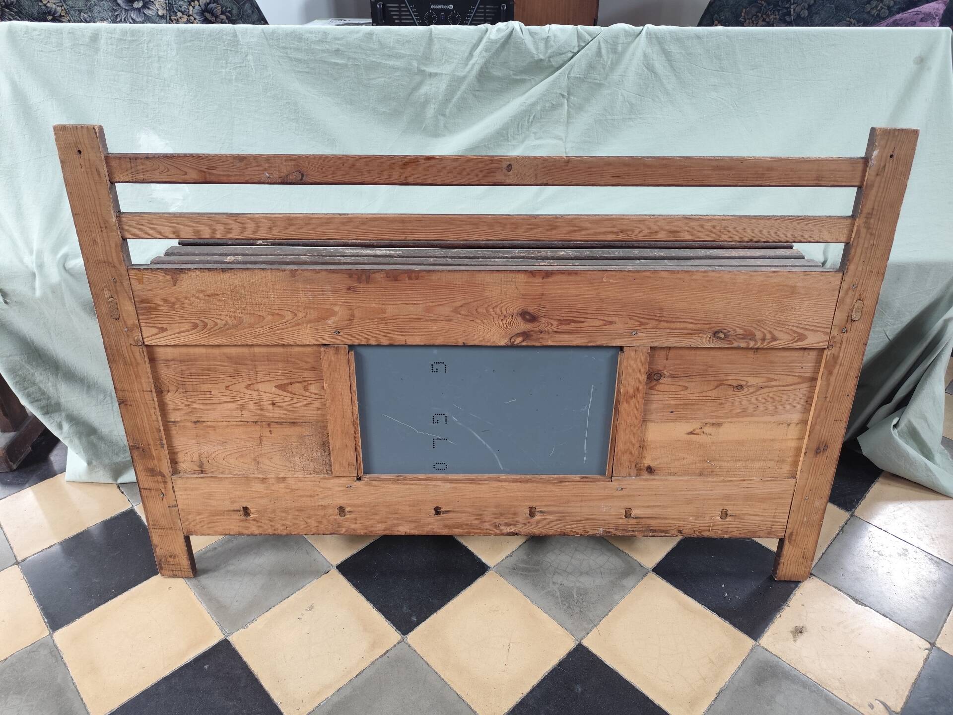 Wall-mounted coat rack with mirror and hat holder.