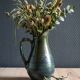 Vintage ceramic pitcher vase in glazed green and blue.