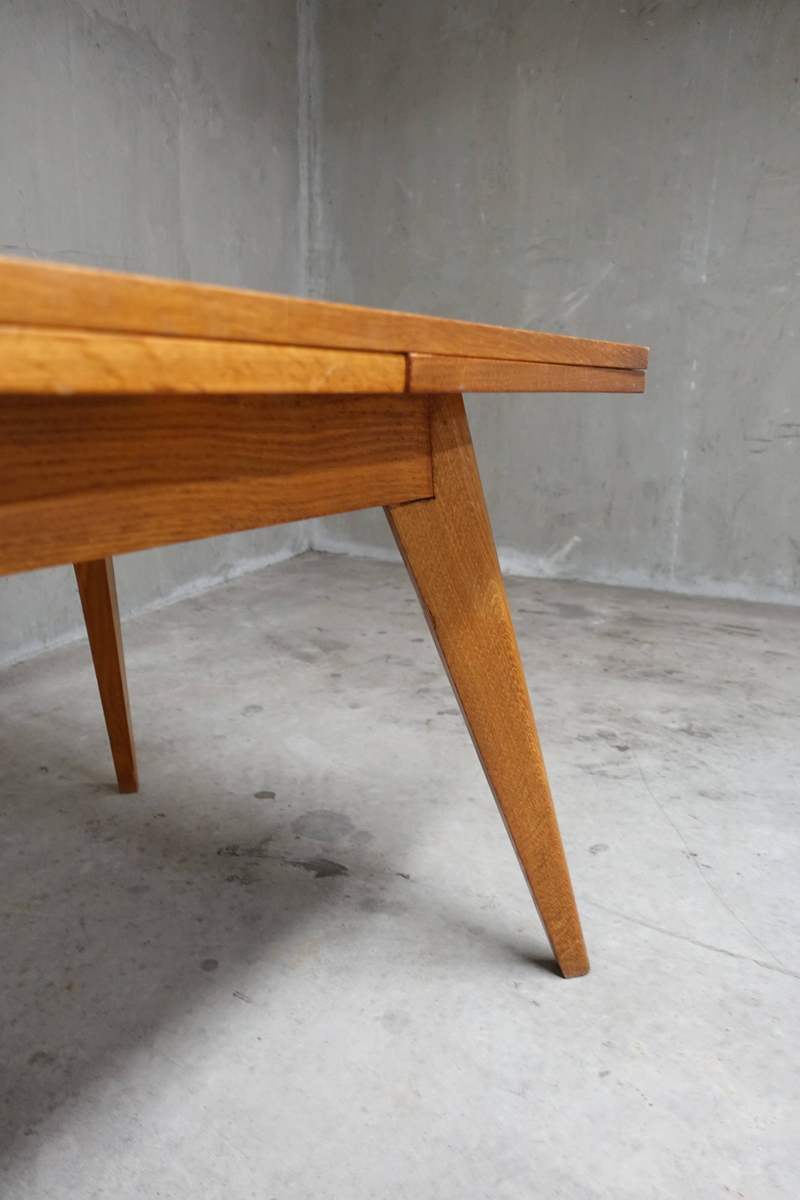 Dining table in blond oak compass feet 1950