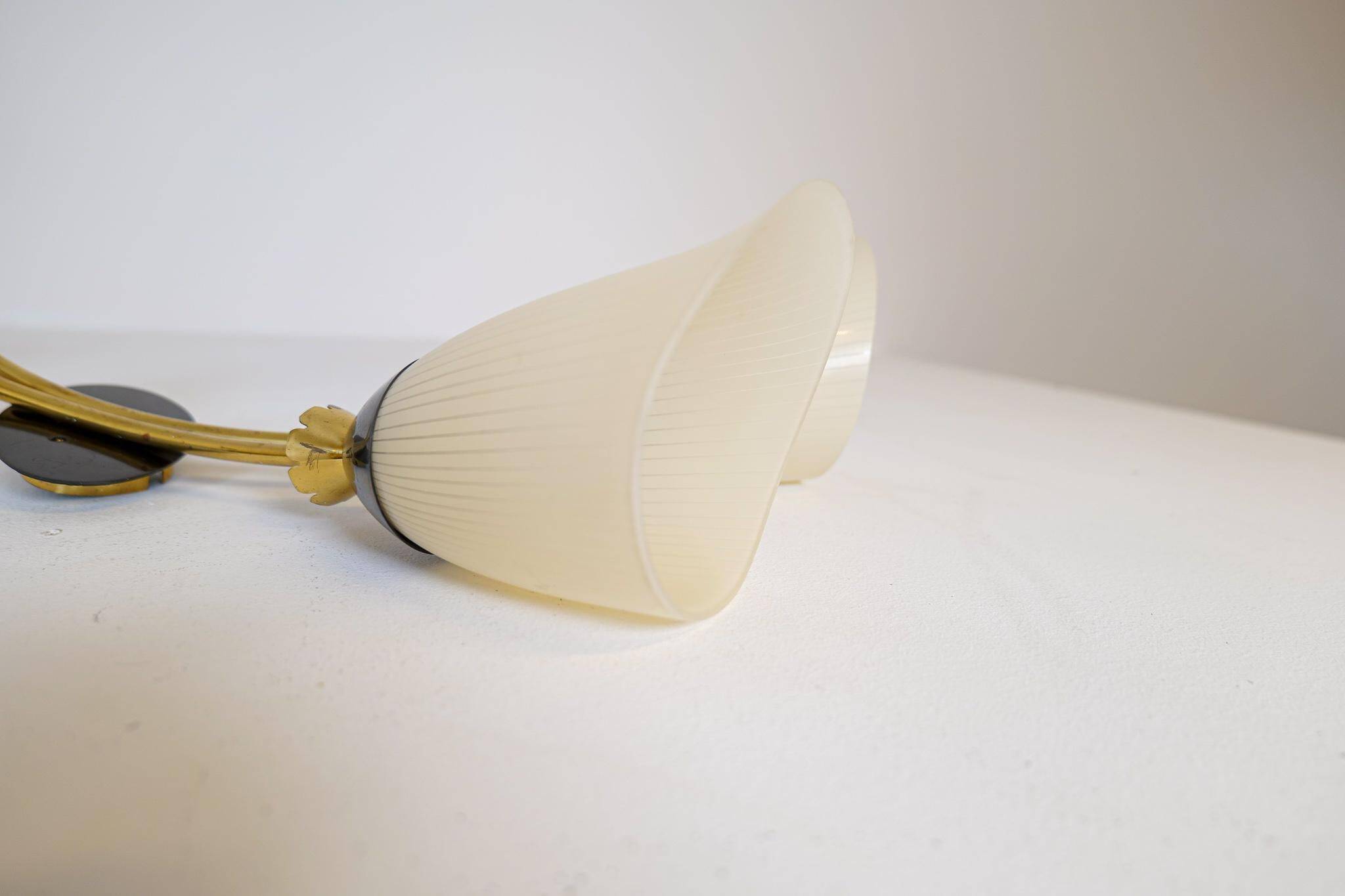 Mid-century pair of wall lamps in brass and opaline attributed to Asea Sweden, 1950s.
