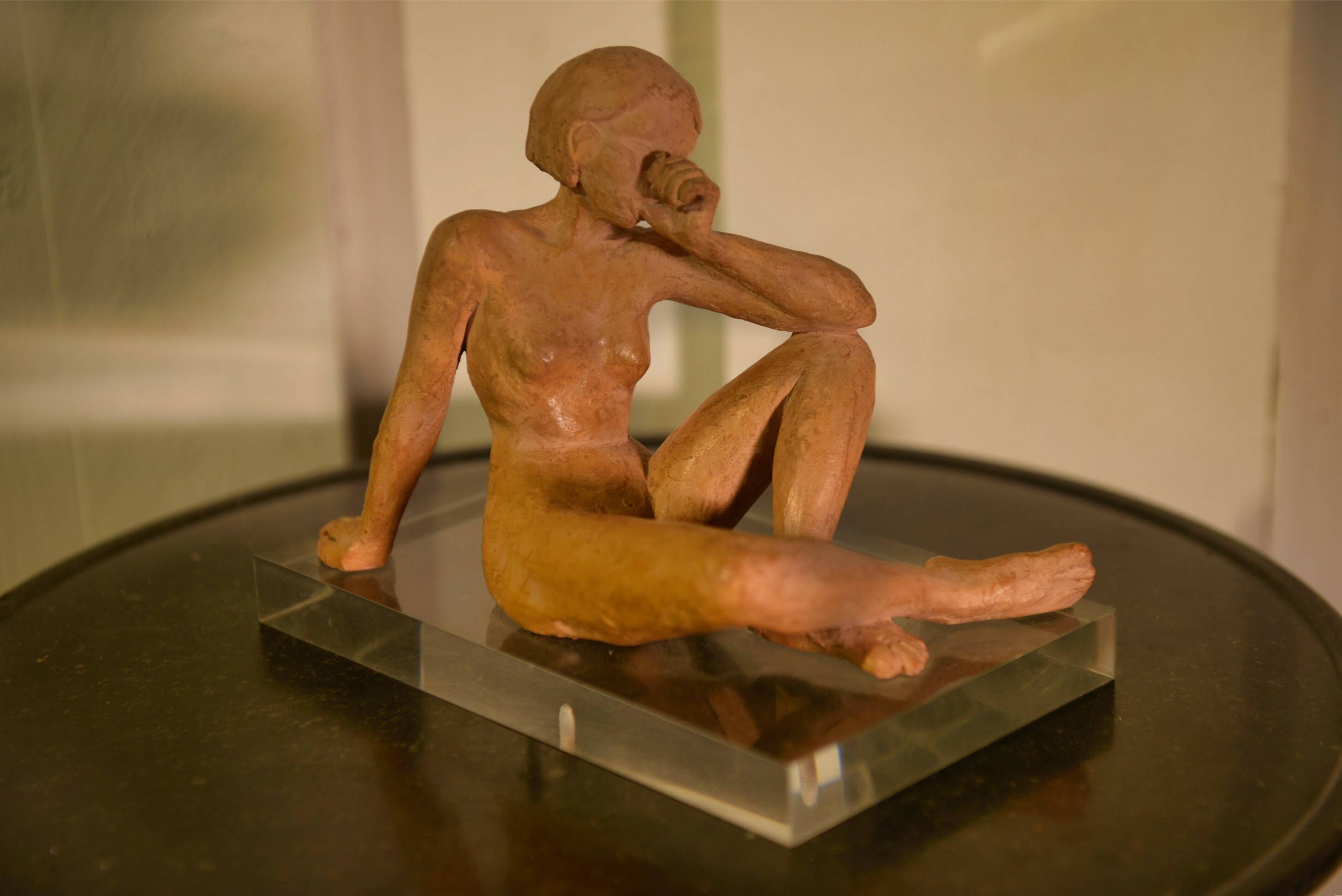 Terracotta sculpture of a seated woman by Norbert Treca contemporary art.