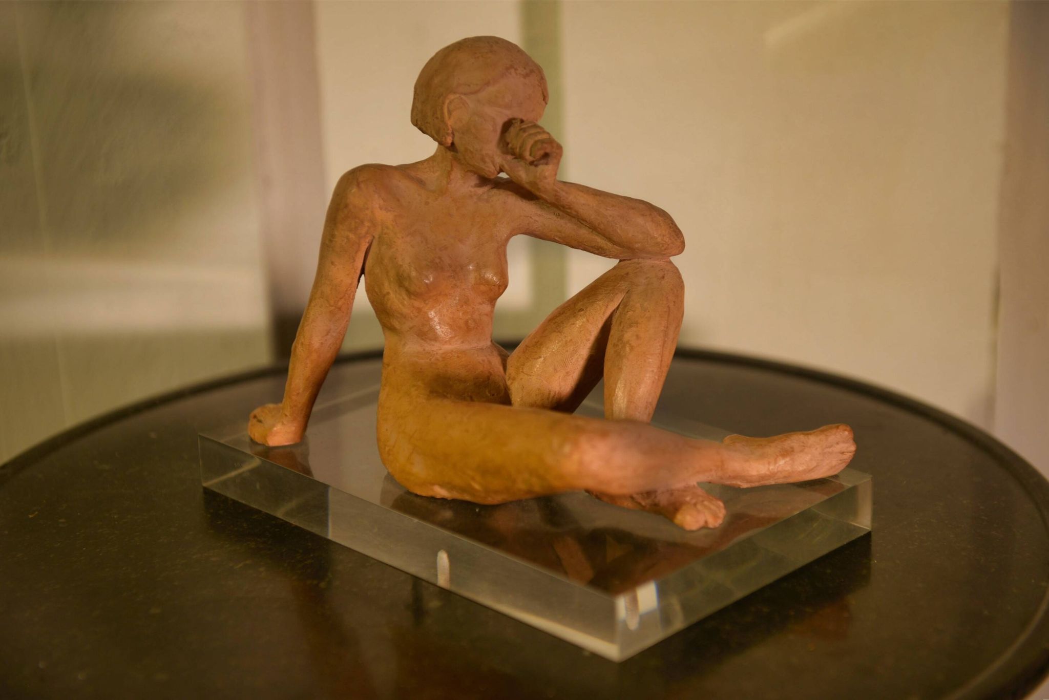 Terracotta sculpture of a seated woman by Norbert Treca contemporary art.