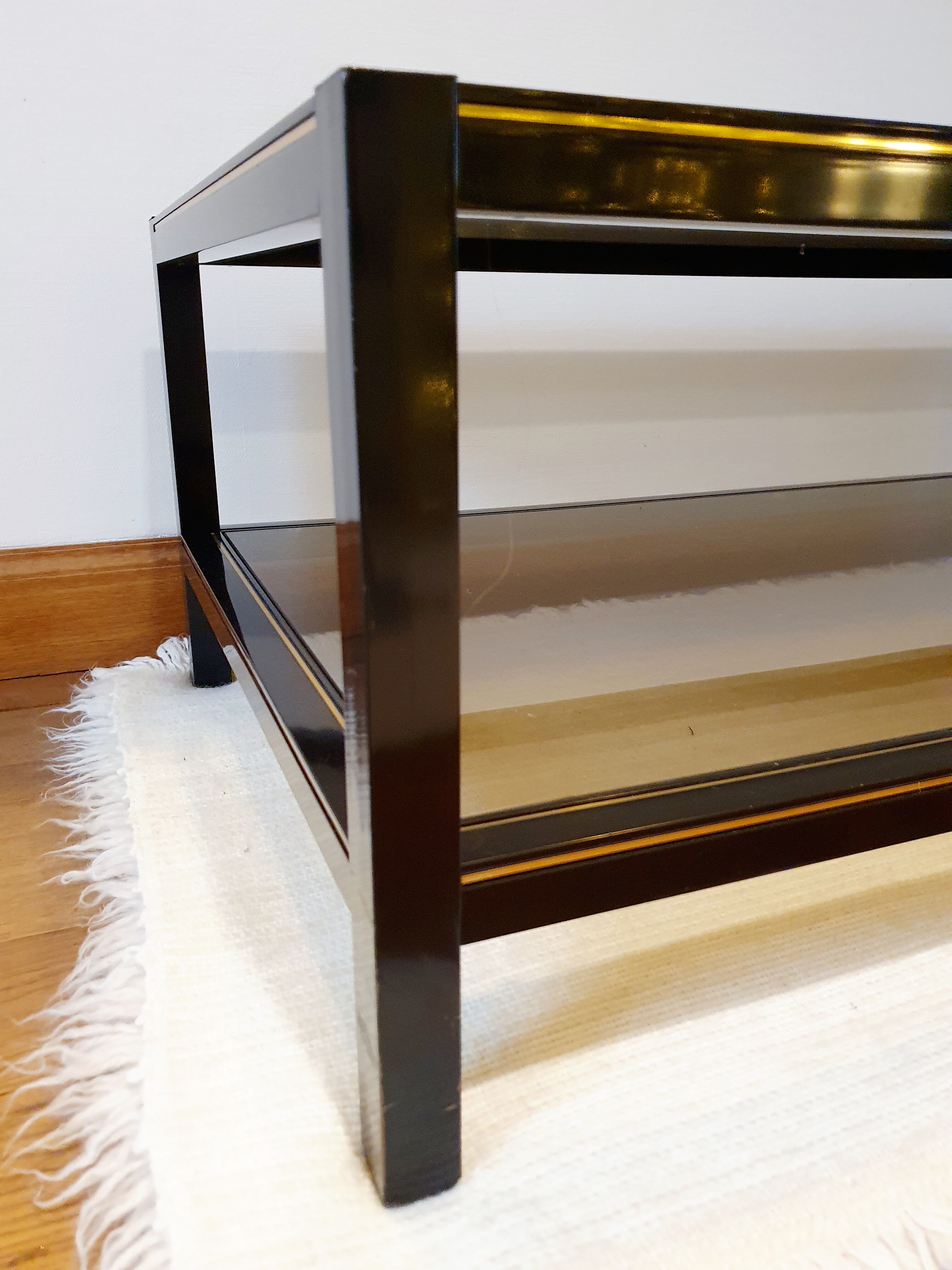 Black and gold coffee table with a double smoked glass top