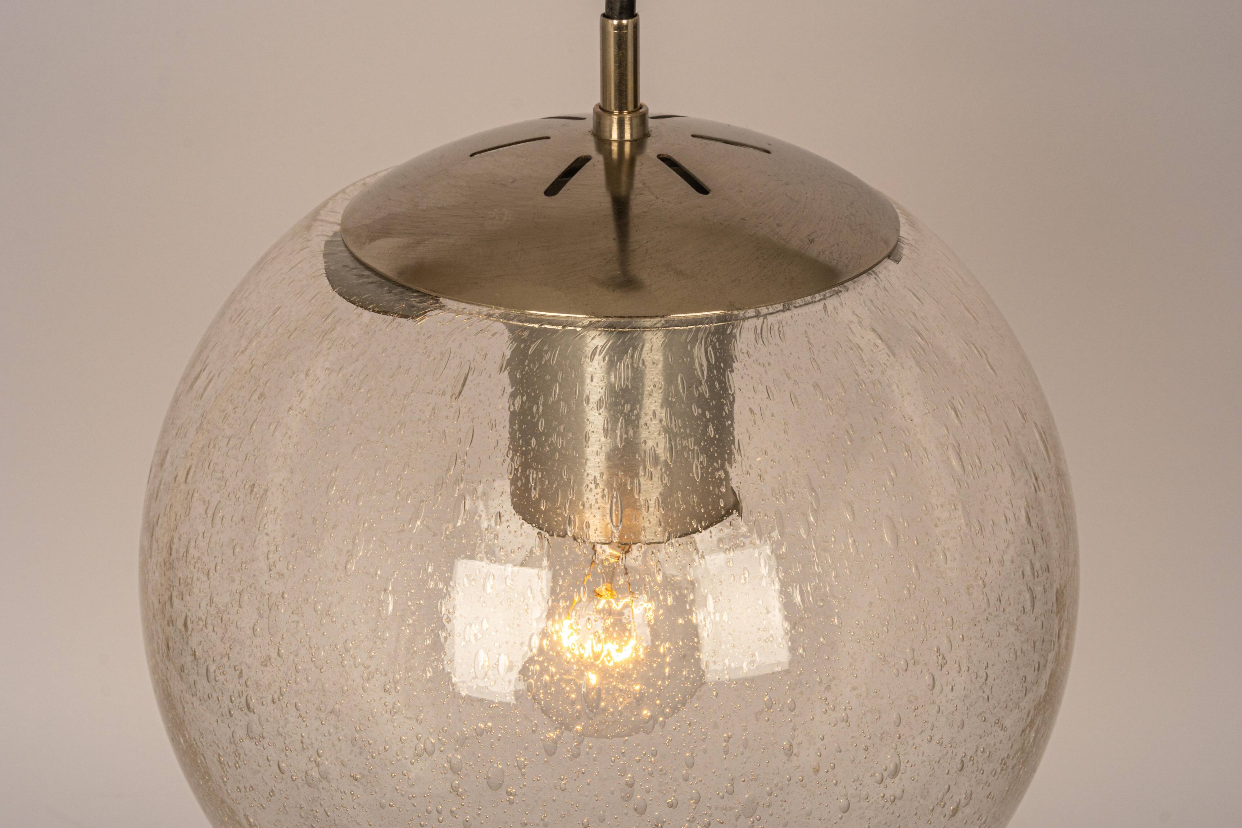 Small Limburg chrome pendant light with transparent glass ball, Germany, 1970s.