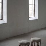 Pair of mid-century Danish oak stools with shearling lambswool upholstery, 1950s.