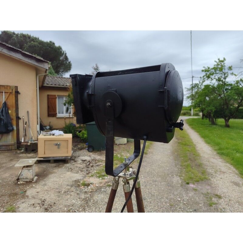 Spotlight on wooden and chrome tripod.