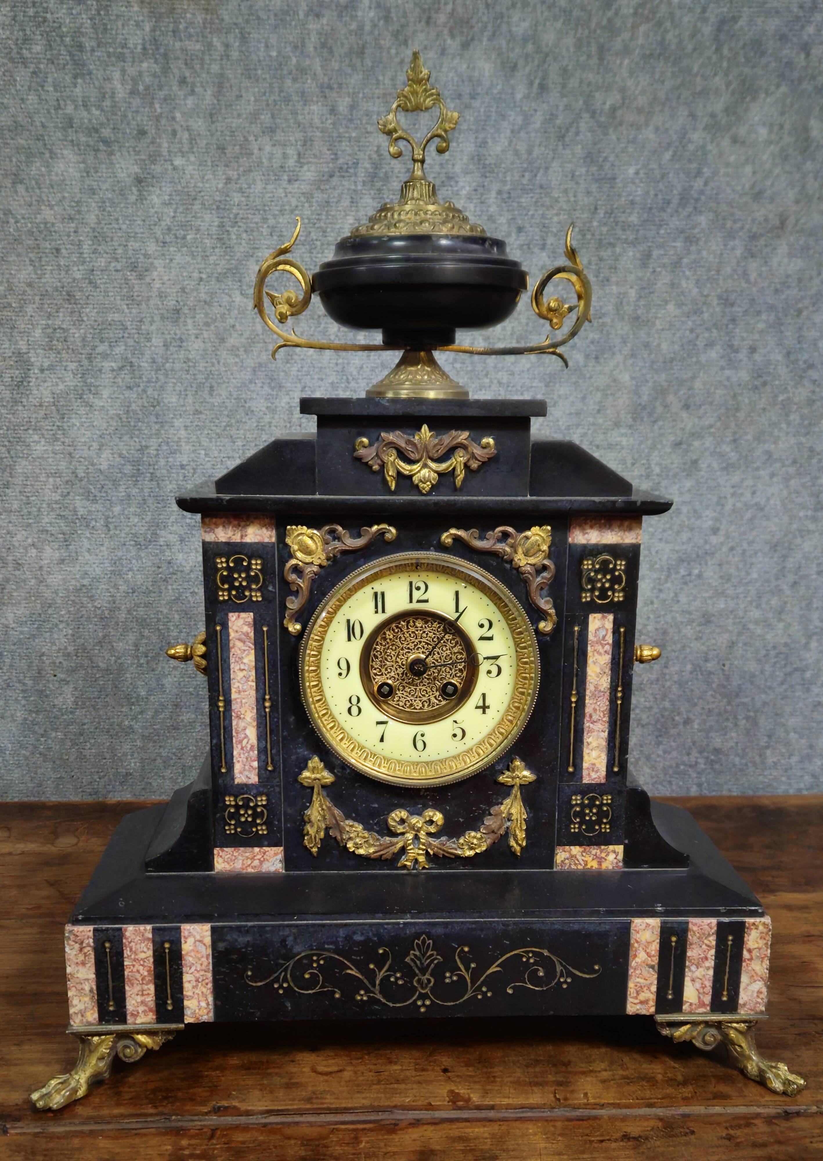Large notary clock in black marble and gilded bronze.