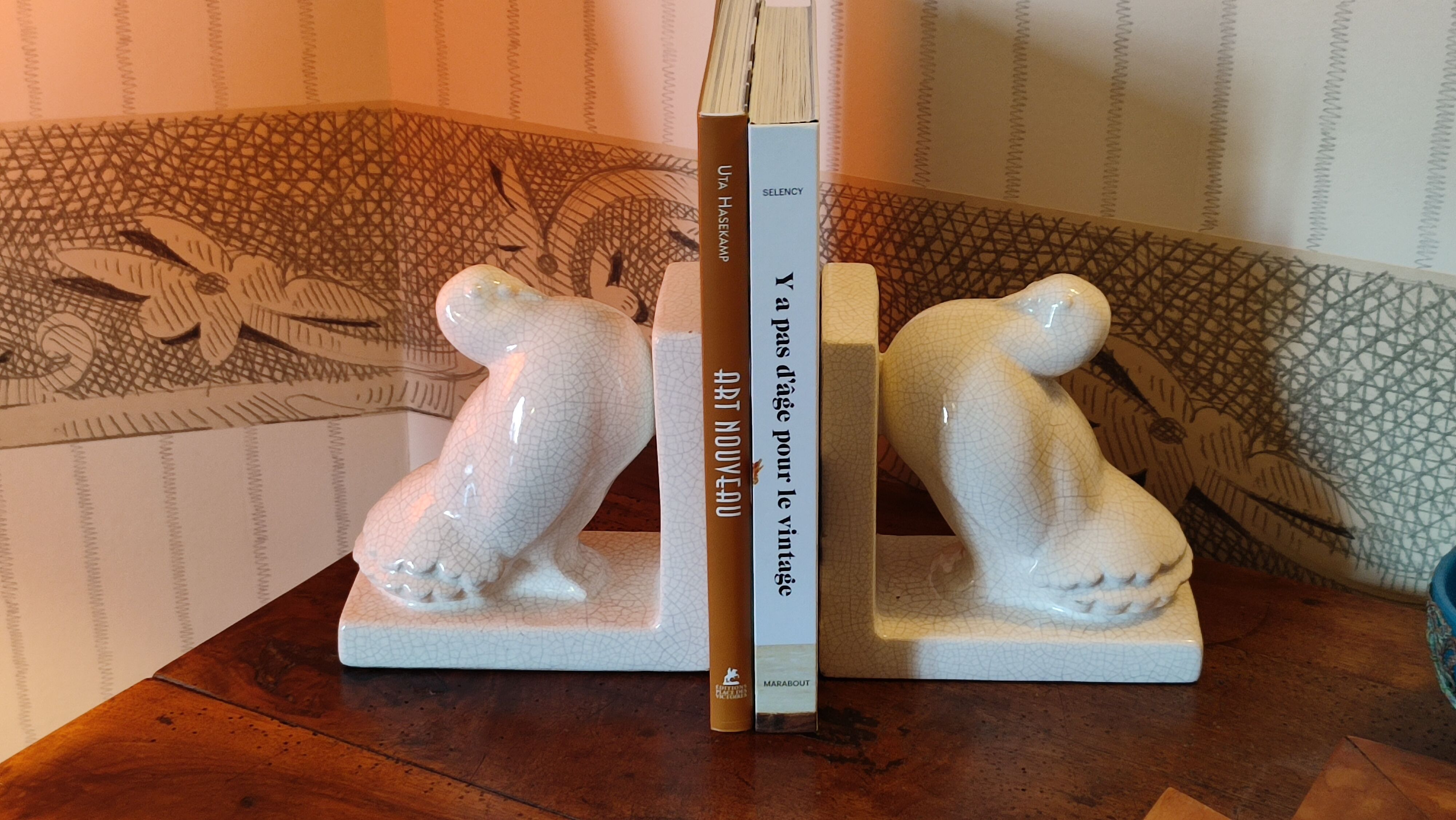 Pair of greenhouse art-deco books about cracked earthenware bird