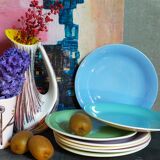 Seven pastel-colored plates mixed with vintage earthenware