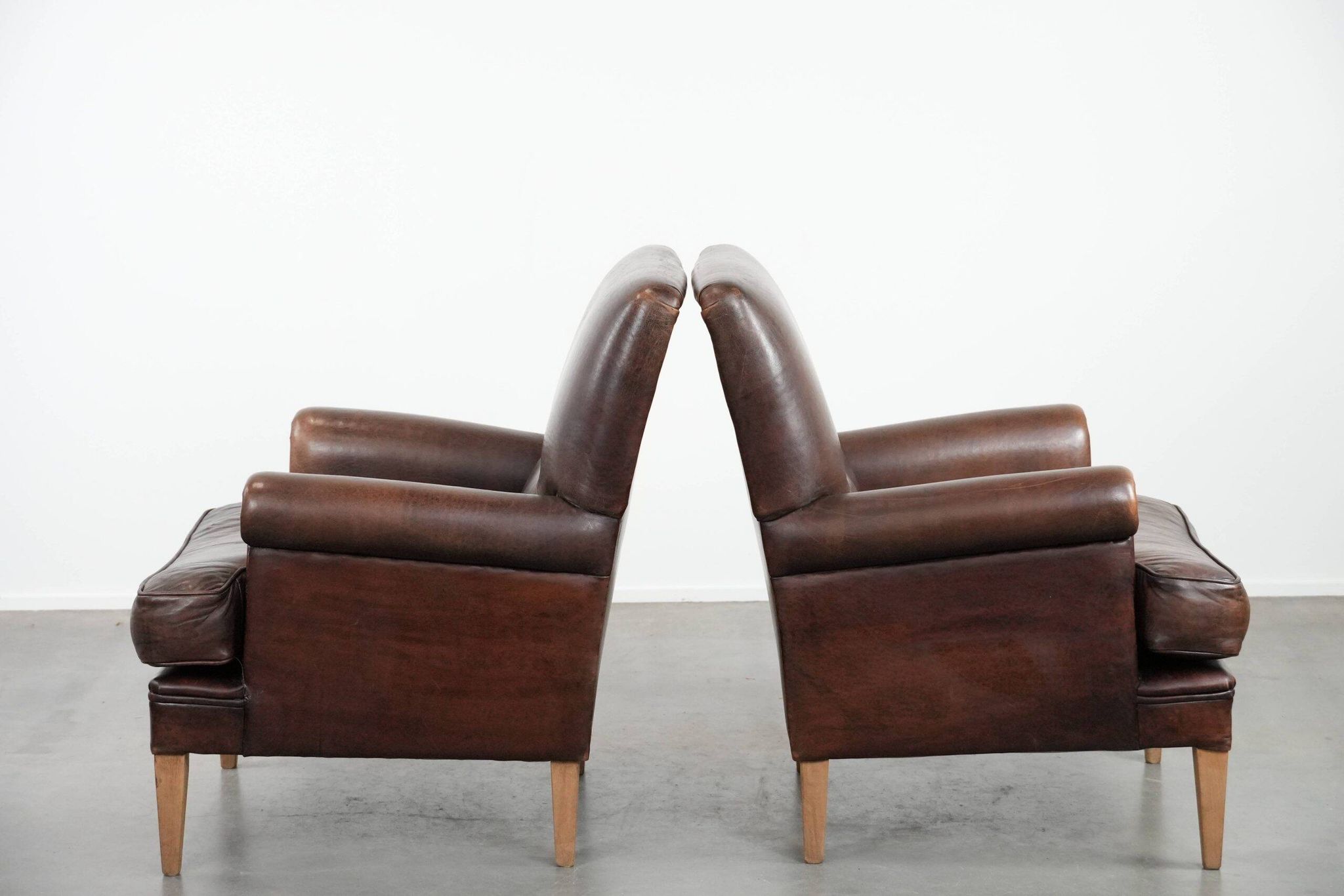 Set of two characterful sheepskin armchairs with a beautiful deep colour