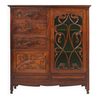 Remarkable Art Nouveau cabinet in oak with green glass door and floral decoration, France, 1910