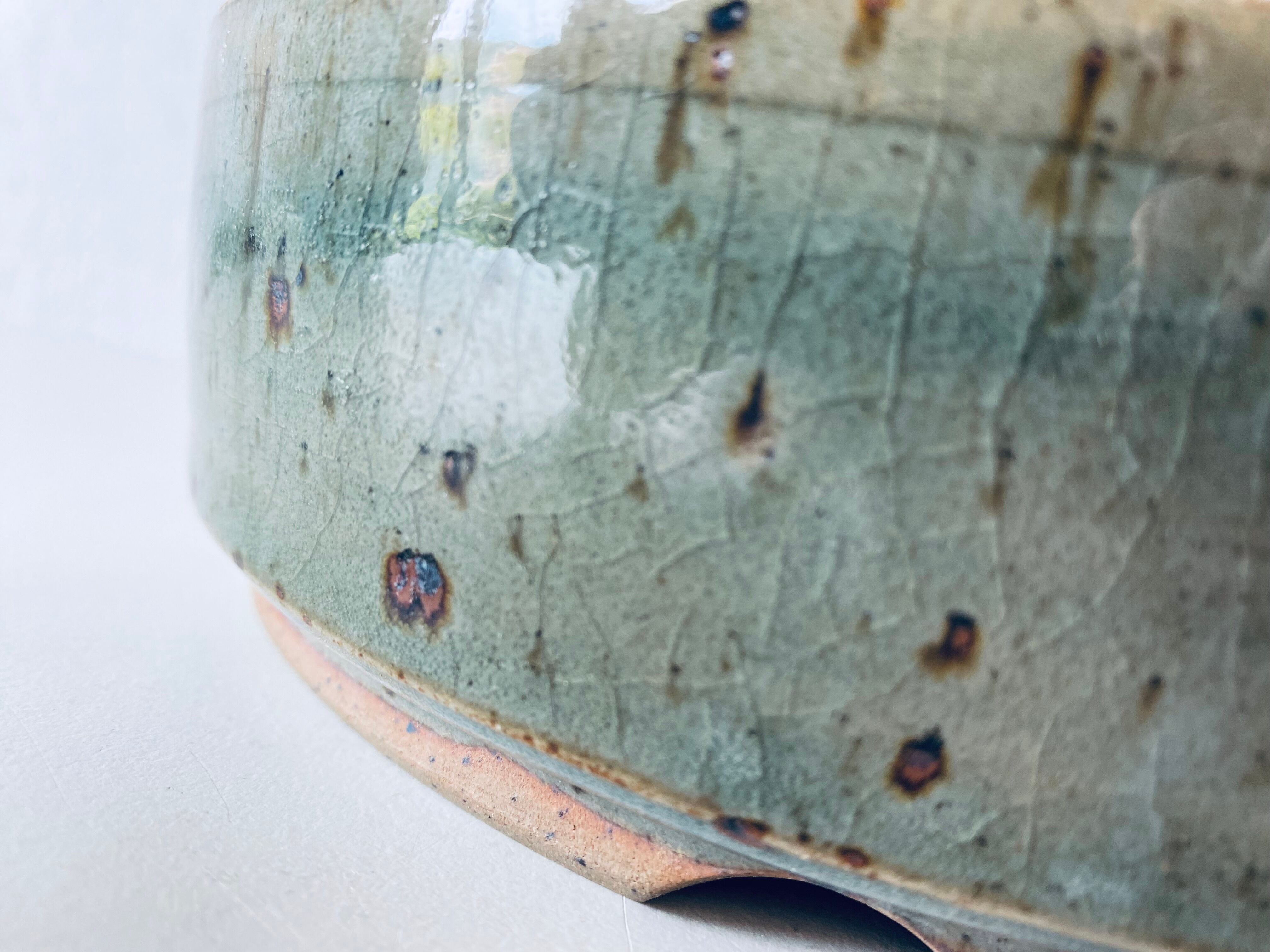 Pierced glazed stoneware cup