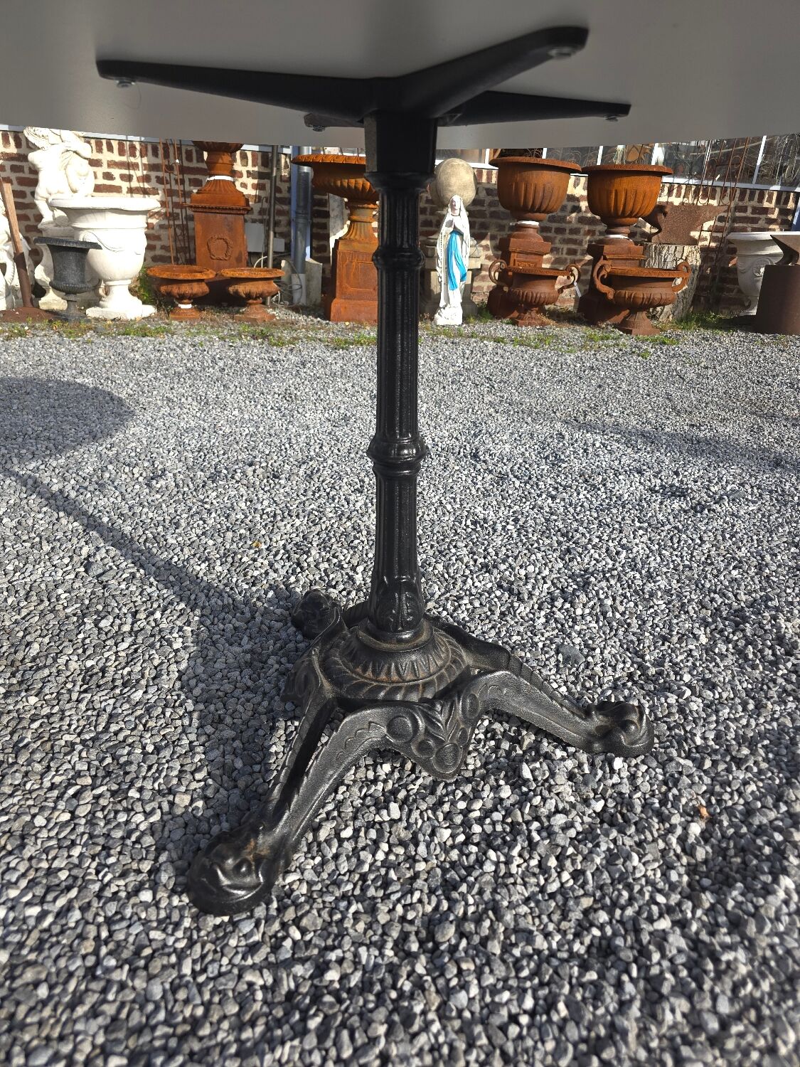 Bistro pedestal table with cast iron base and marble effect top