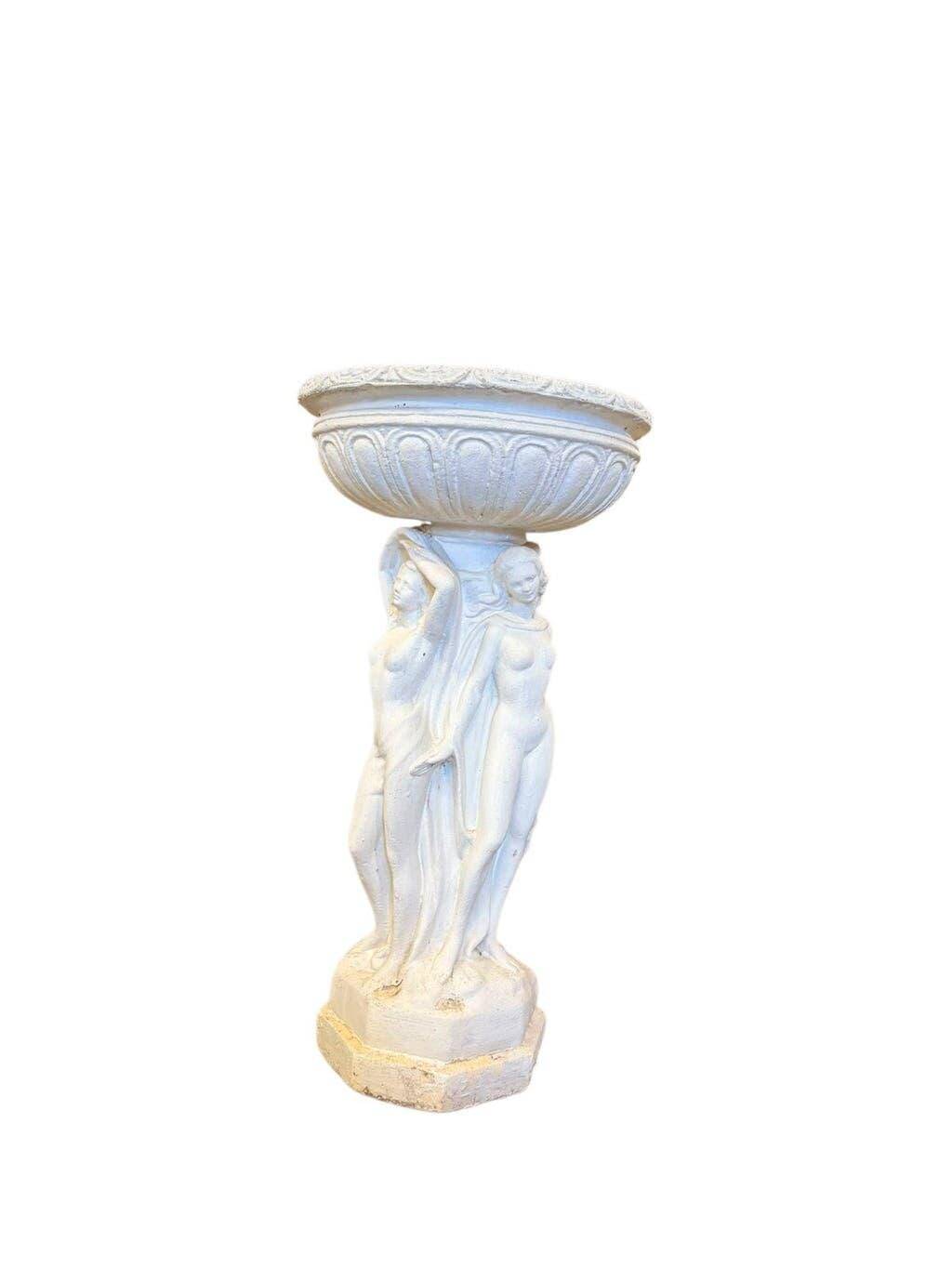 Vintage white concrete garden statue adorned with planter.