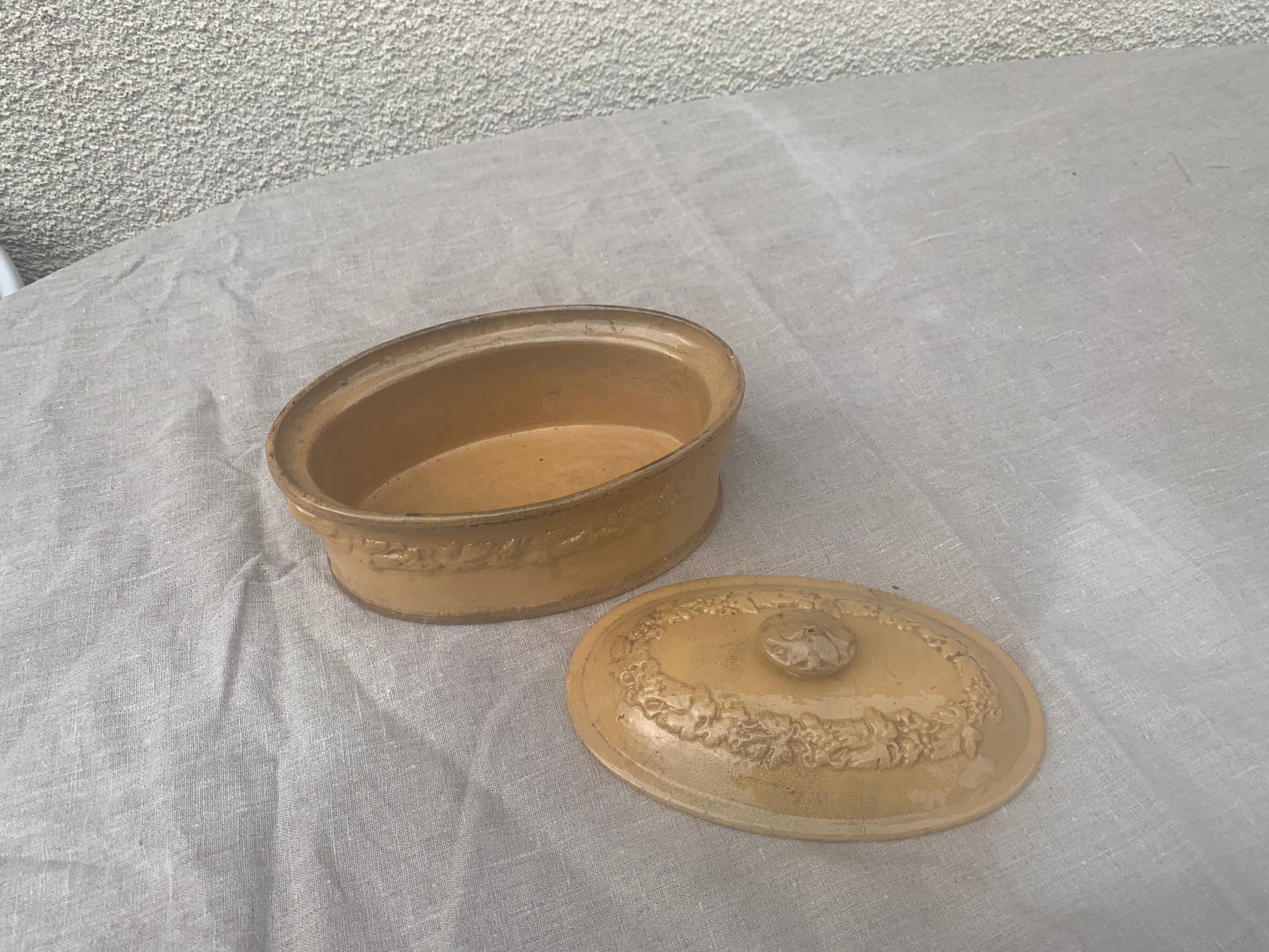 Old terrine in glazed stoneware and floral decoration mustard yellow slip