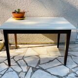 Vintage oak farmhouse table with a white top.