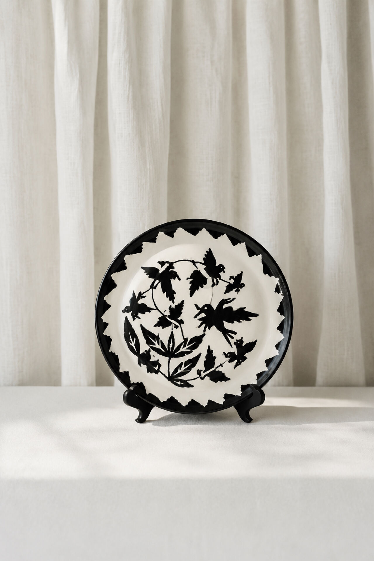 Large ceramic plate J. Lurçat with zoomorphic decoration in black on a white background.