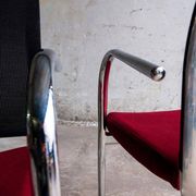Set of 4 cantilever chairs with burgundy seat and mesh backrest.
