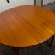 Scandinavian table in round teak with built-in extensions 1960