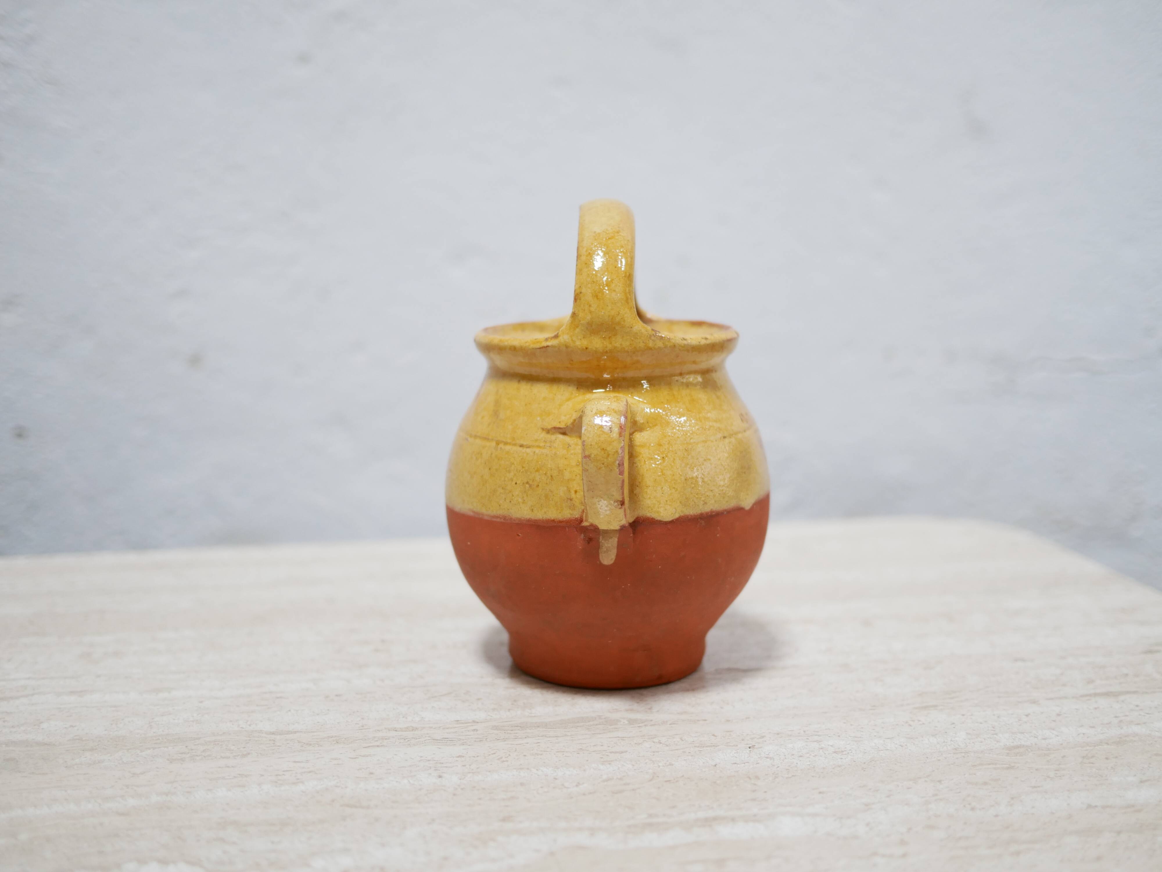 Old gargoulette pot in glazed terracotta