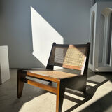 Reclined armchair in canned teak in natural wood