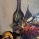 Still life with bottle and game, signed, 20th century