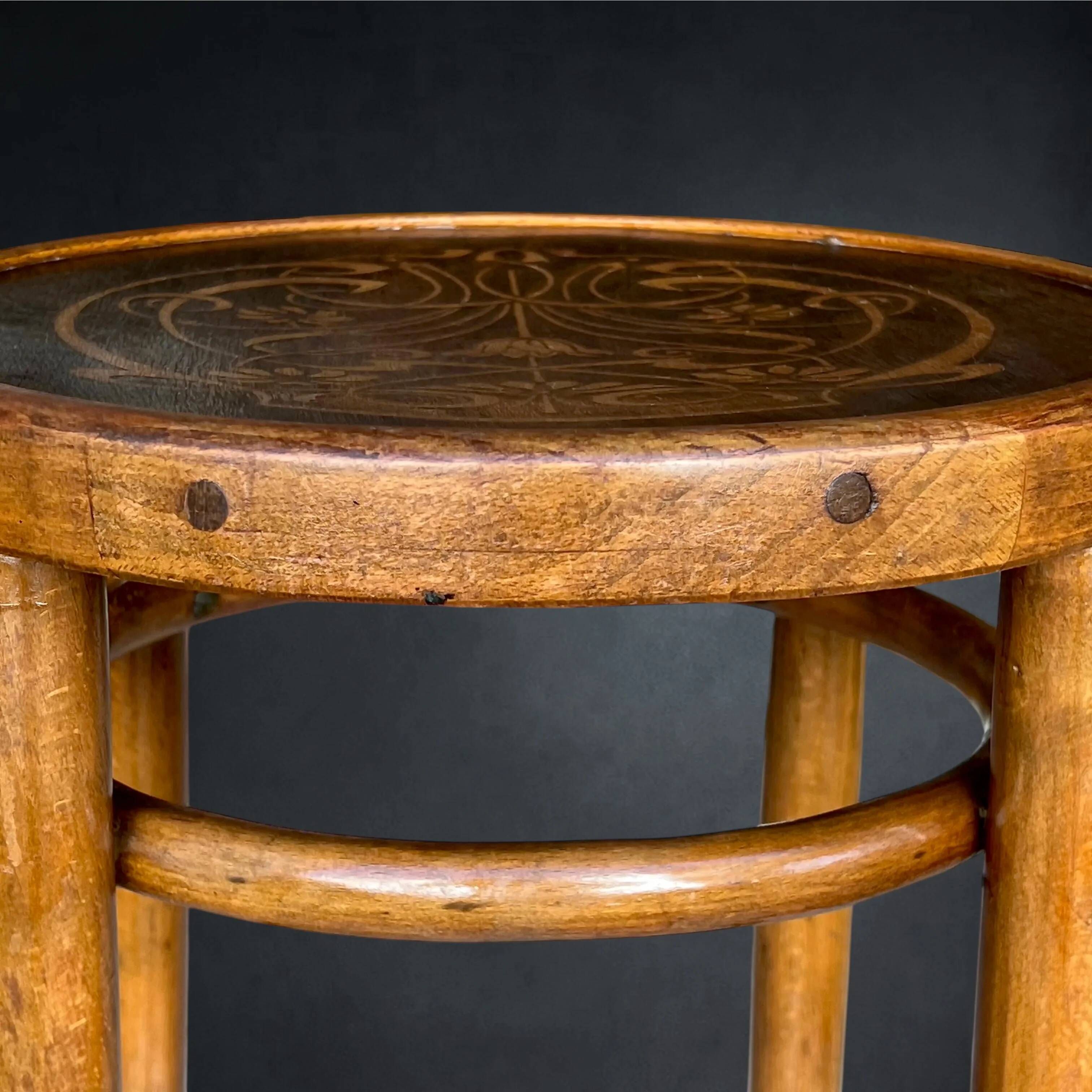 Antique high bistro stool in curved wood with a floral decorated top, Thonet style – around 1900